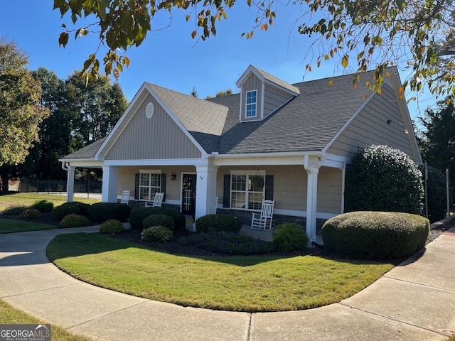 view of front facade with covered porch and a front yard