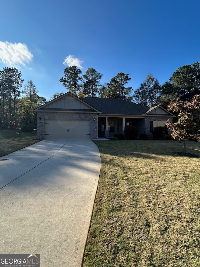 view of front of property with a garage and a front yard