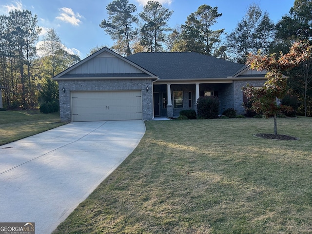 view of front of property with a garage and a front lawn