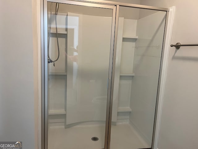 bathroom with a shower with shower door