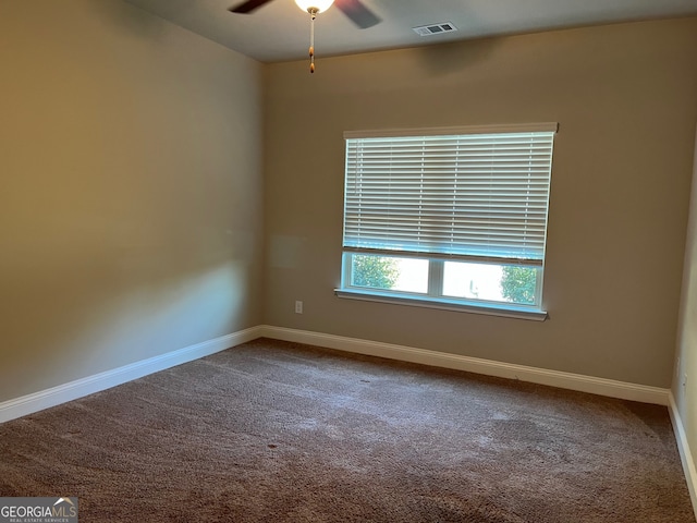 empty room featuring ceiling fan and carpet floors