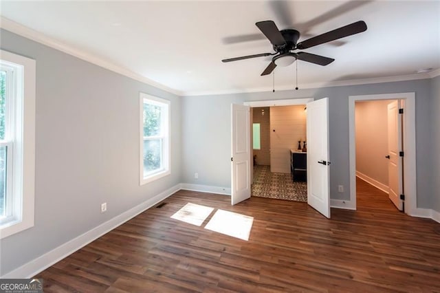 unfurnished bedroom featuring dark hardwood / wood-style flooring, crown molding, and ceiling fan