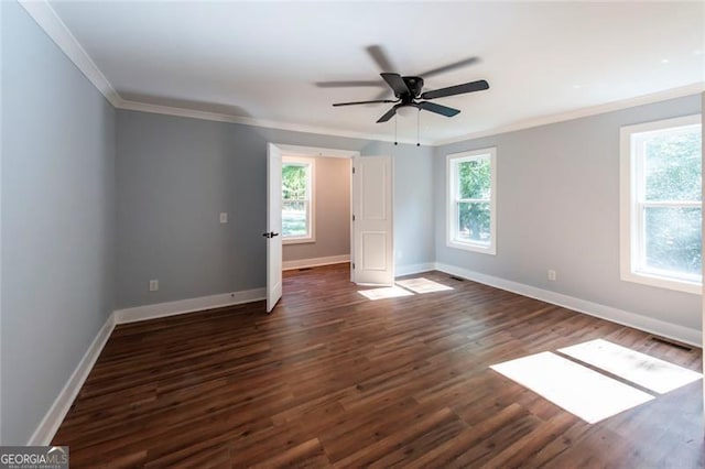 empty room with ceiling fan, crown molding, and dark hardwood / wood-style floors