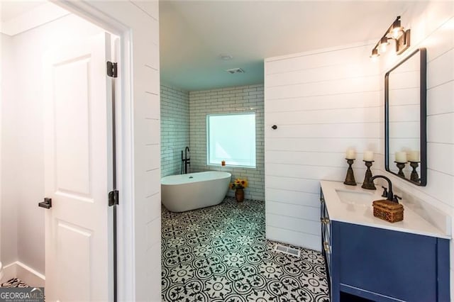 bathroom with vanity and a bathing tub