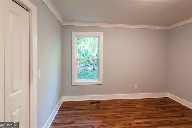 unfurnished room with crown molding and dark hardwood / wood-style floors