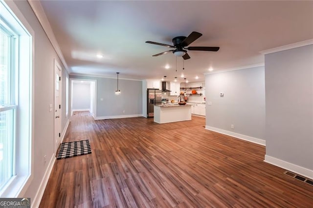 unfurnished living room featuring crown molding, dark wood-type flooring, and ceiling fan