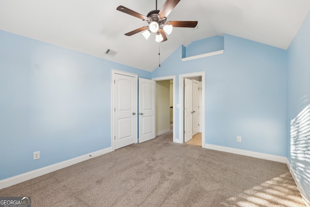 unfurnished bedroom featuring light colored carpet, lofted ceiling, and ceiling fan