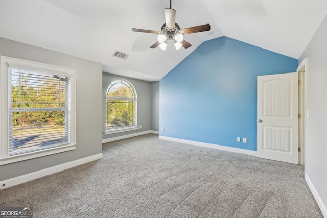 unfurnished room featuring ceiling fan, vaulted ceiling, and carpet