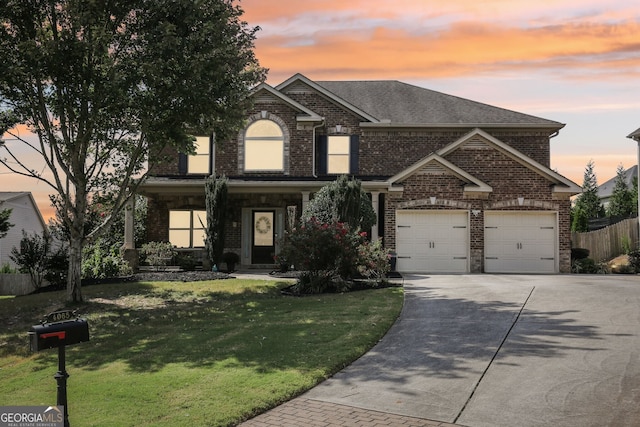 view of front of property featuring a garage and a yard