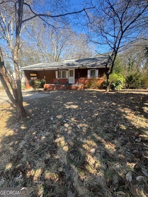 view of front of home featuring an attached carport and driveway