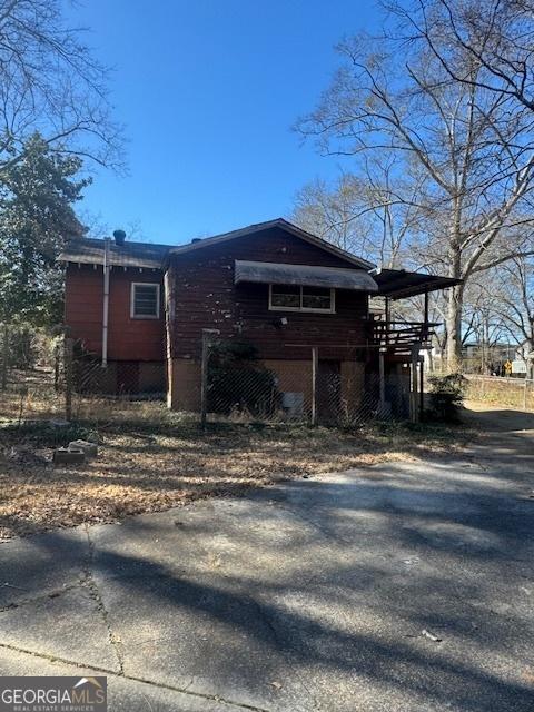 view of side of home with driveway