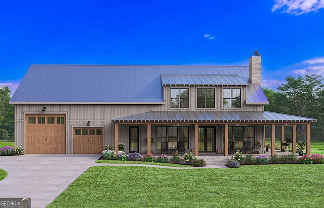 modern farmhouse style home featuring concrete driveway, a chimney, metal roof, a standing seam roof, and a front yard