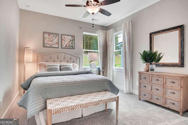 bedroom featuring light carpet and ceiling fan