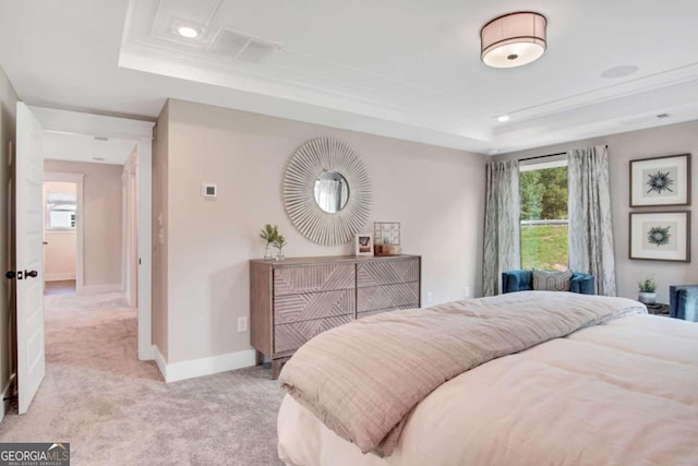 carpeted bedroom featuring ornamental molding and a raised ceiling