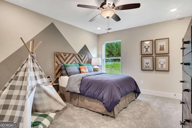 bedroom with ceiling fan and light colored carpet