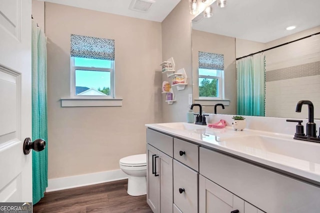 bathroom with toilet, hardwood / wood-style flooring, vanity, and a shower with curtain