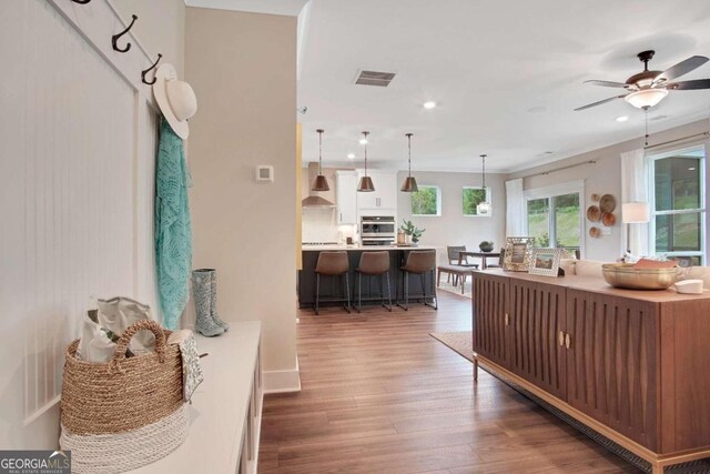 sunroom featuring ceiling fan