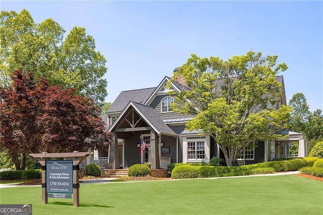 view of front of house with a porch and a front lawn