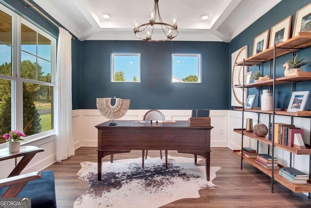 home office featuring a notable chandelier, a tray ceiling, and dark hardwood / wood-style floors