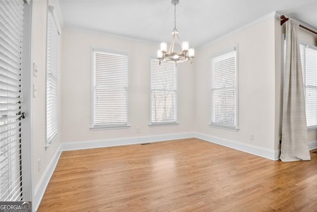 unfurnished dining area featuring crown molding, light hardwood / wood-style flooring, and a healthy amount of sunlight