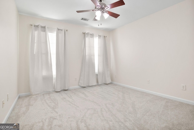 spare room featuring ceiling fan and light colored carpet