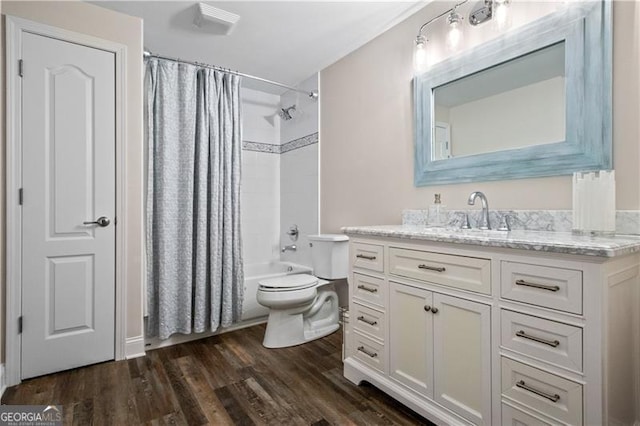 full bathroom featuring vanity, wood-type flooring, shower / tub combo, and toilet