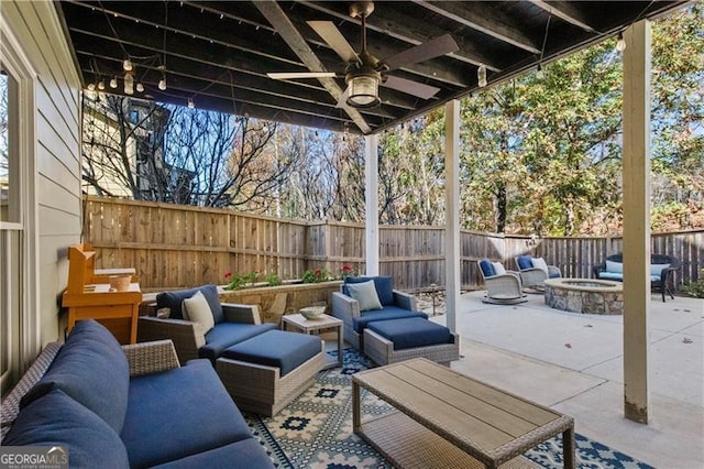 view of patio with an outdoor living space with a fire pit and ceiling fan