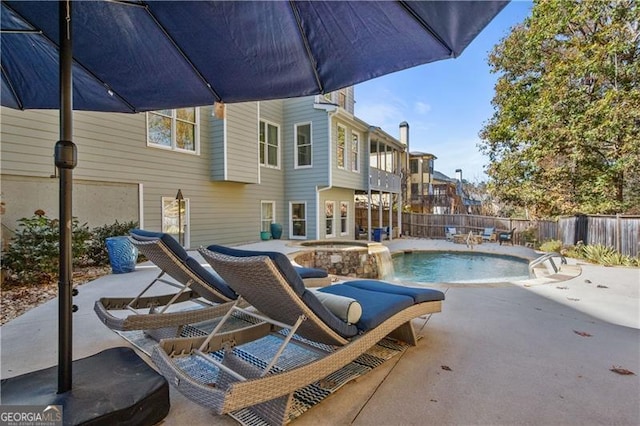 view of swimming pool featuring an outdoor hot tub and a patio