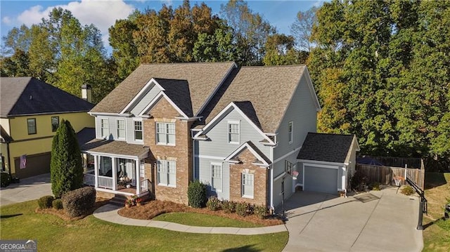 view of front of property with an outbuilding, a garage, a front lawn, and covered porch