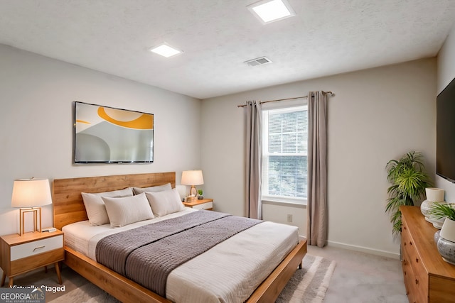 carpeted bedroom with a textured ceiling