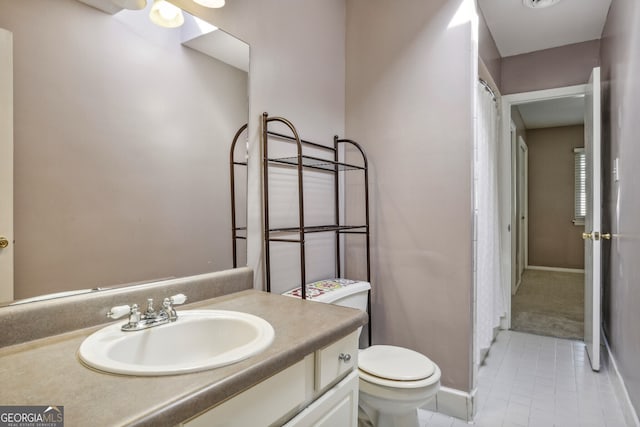 bathroom featuring vanity, toilet, and tile patterned floors