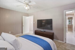 carpeted bedroom featuring ceiling fan