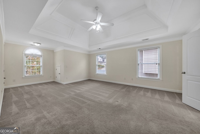 empty room featuring a wealth of natural light, crown molding, and light carpet