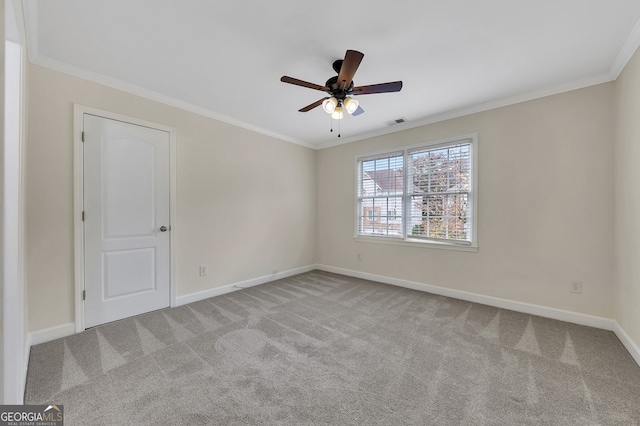 unfurnished room with crown molding, light colored carpet, and ceiling fan