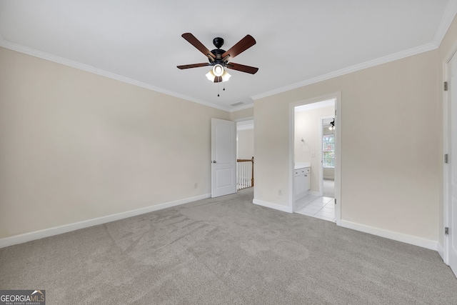 unfurnished bedroom featuring crown molding, light carpet, ensuite bathroom, and ceiling fan