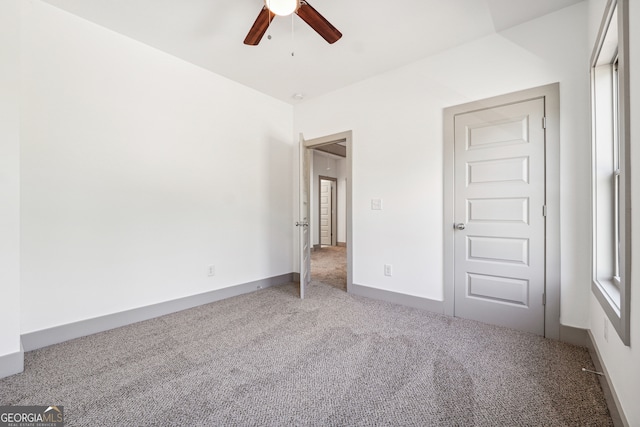 unfurnished bedroom with a closet, ceiling fan, and carpet flooring