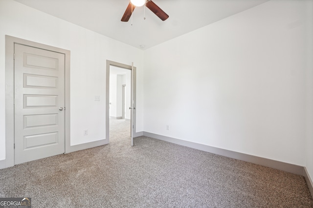 empty room with carpet and ceiling fan