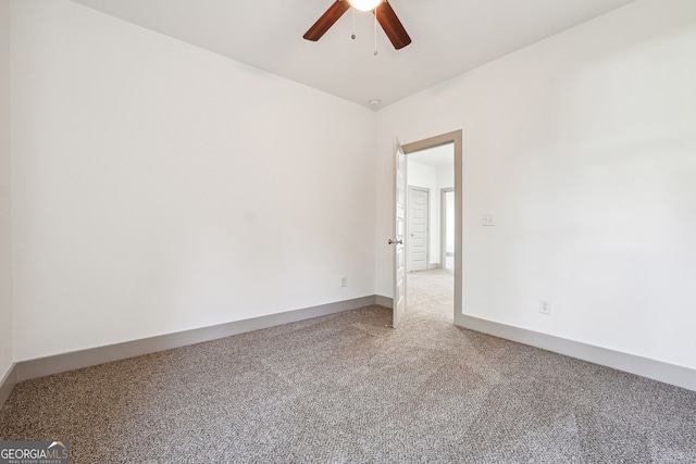 spare room featuring carpet flooring and ceiling fan