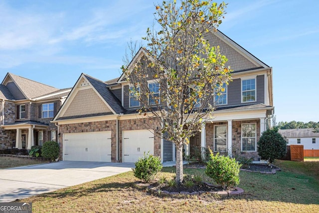 craftsman-style home featuring a garage and a front lawn