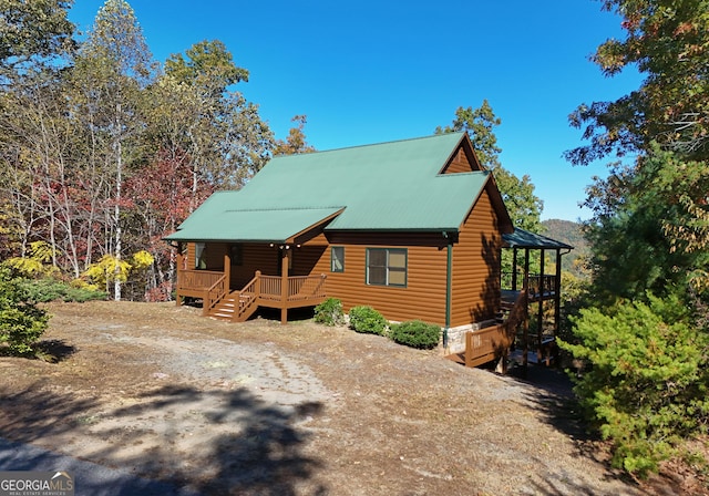 log cabin featuring a deck