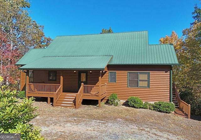 log-style house with a porch