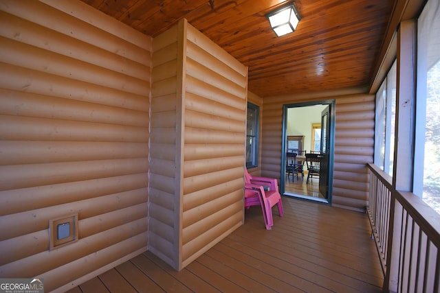 unfurnished sunroom featuring wood ceiling