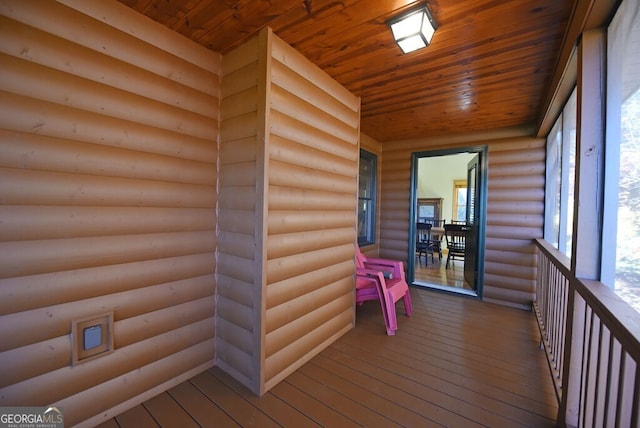 unfurnished sunroom with wood ceiling