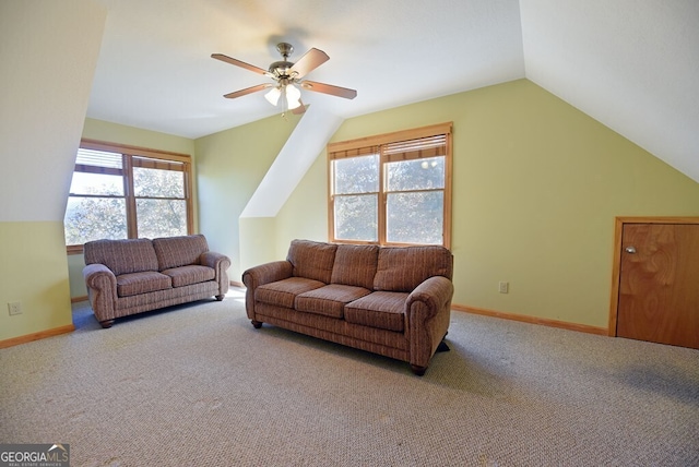 carpeted living room with lofted ceiling, ceiling fan, and a healthy amount of sunlight