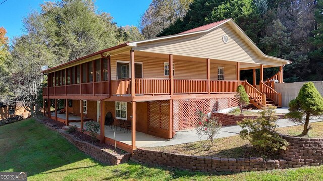 view of property exterior with a patio and a lawn