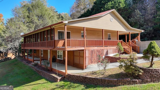 rear view of house with a yard and a patio