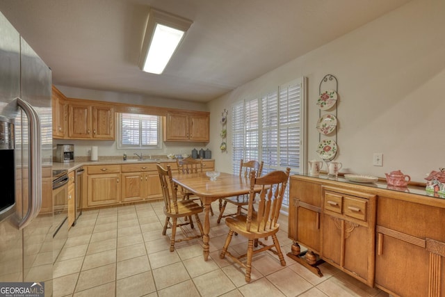 kitchen featuring light countertops, stainless steel fridge with ice dispenser, and light tile patterned floors