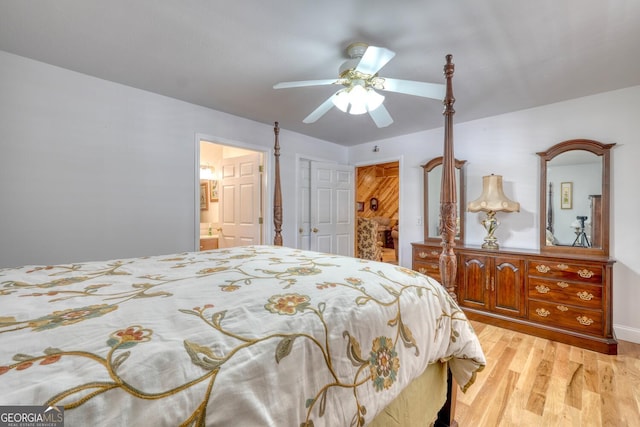 bedroom featuring light wood-type flooring, a ceiling fan, and ensuite bathroom