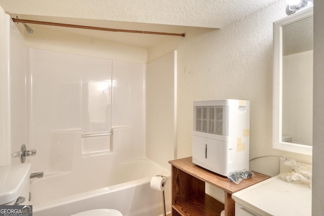 full bath with washtub / shower combination, a textured wall, and toilet