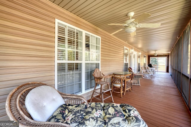 wooden terrace with ceiling fan and a porch